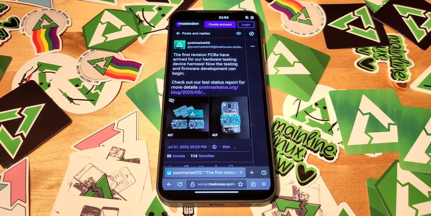 The Fairphone (Gen 6) lying on a table filled with pmOS stickers, showing a mastodon post about PCBs arriving