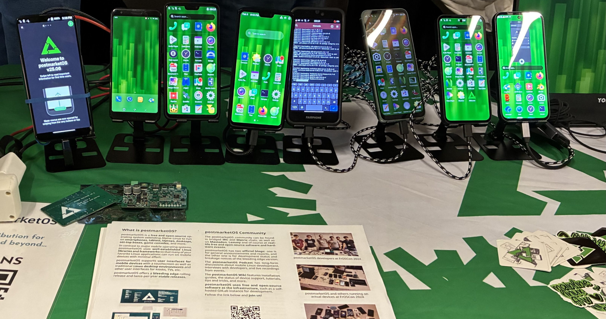 The postmarketOS table with phones, the PCB and stickers
