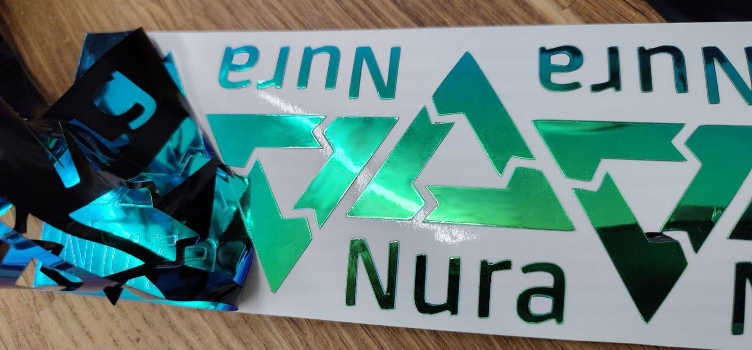 A row of Nura stickers is being produced